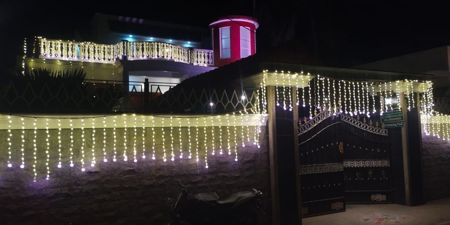 Night view of Villa Serenity Le Sejour Pondicherry decorated with lights.